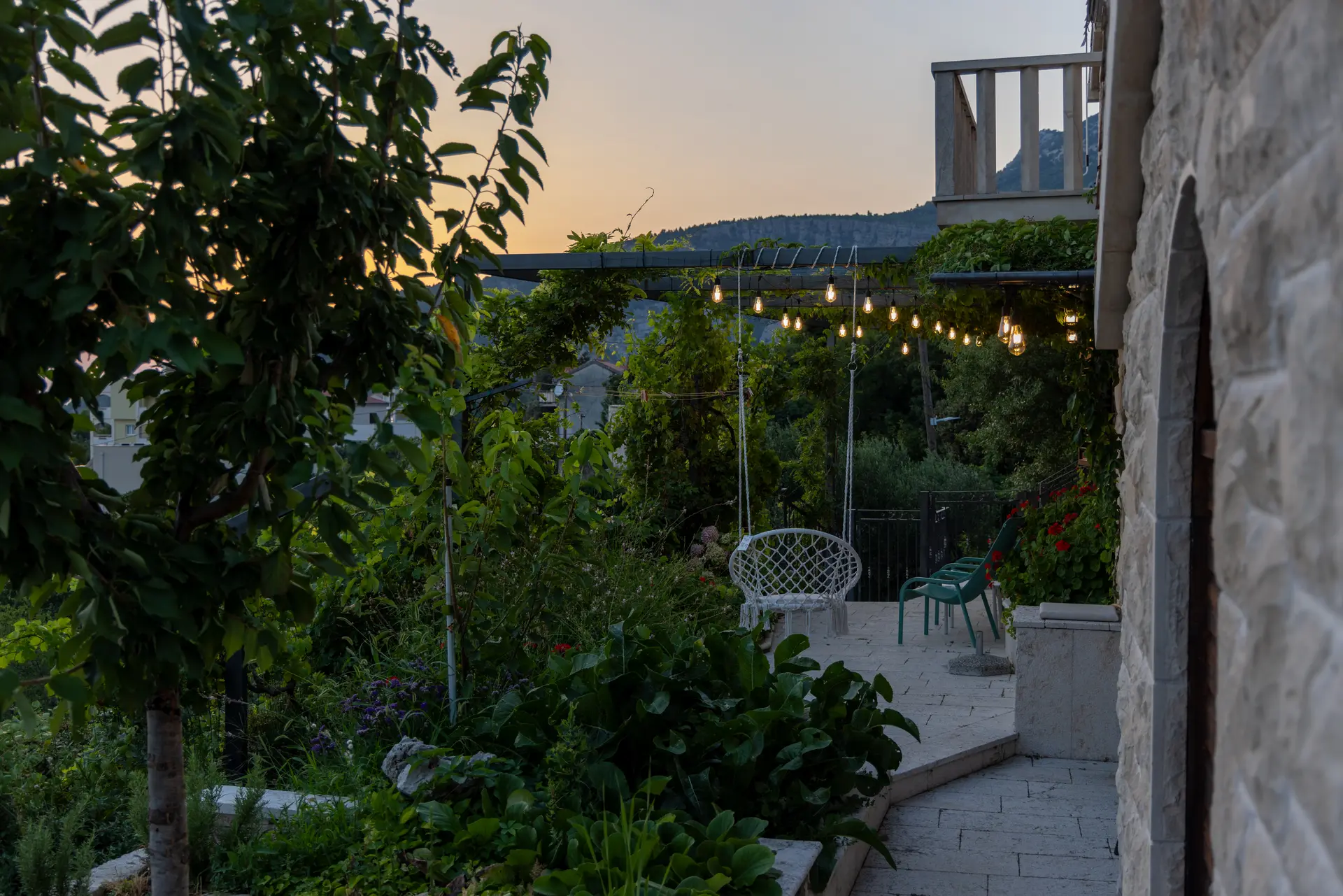 Garden terrace and evening lights beside Villa Dalmatia