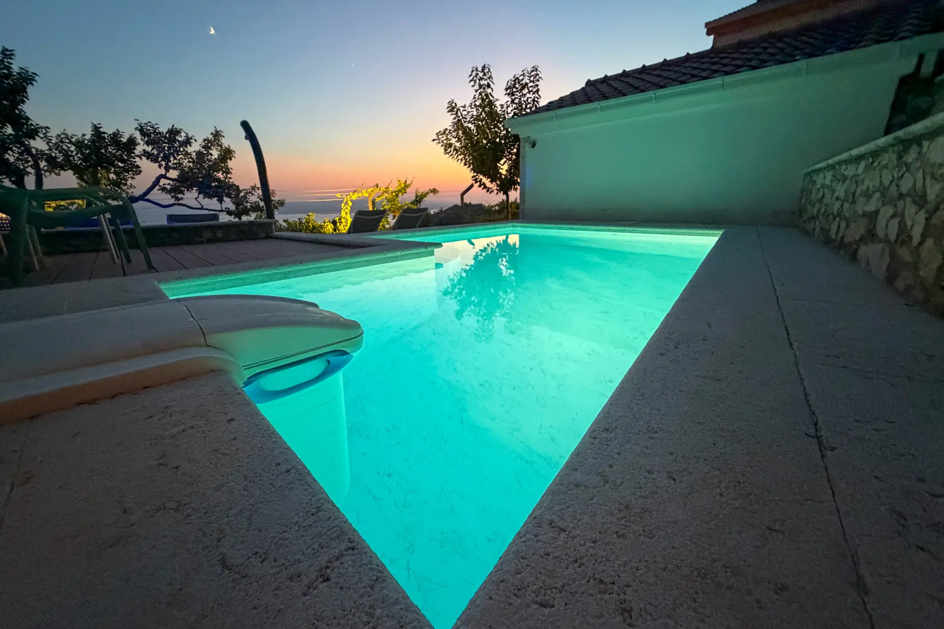 Private pool and stone terrace at Villa Dalmatia at dusk