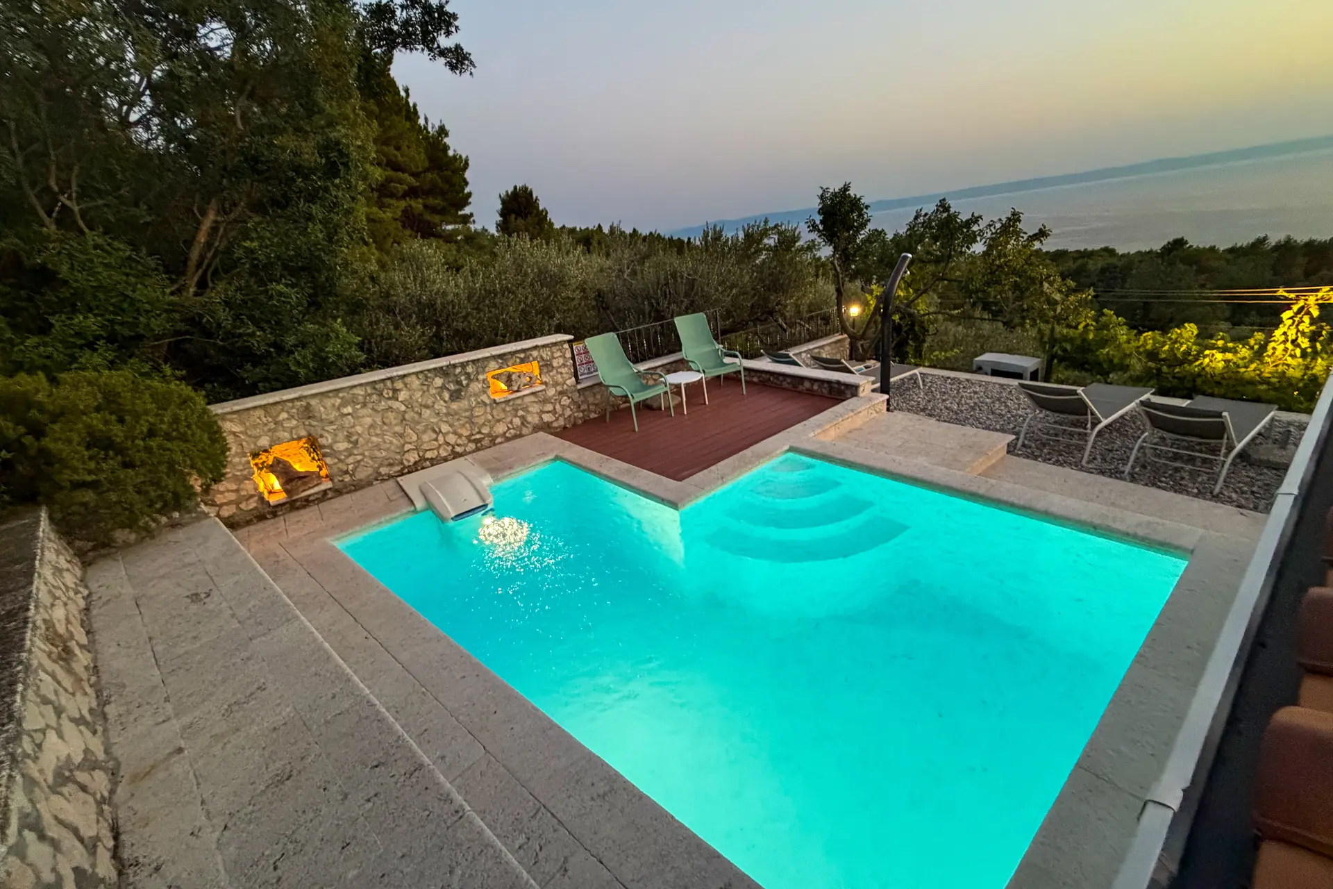 Illuminated private pool at Villa Dalmatia after sunset